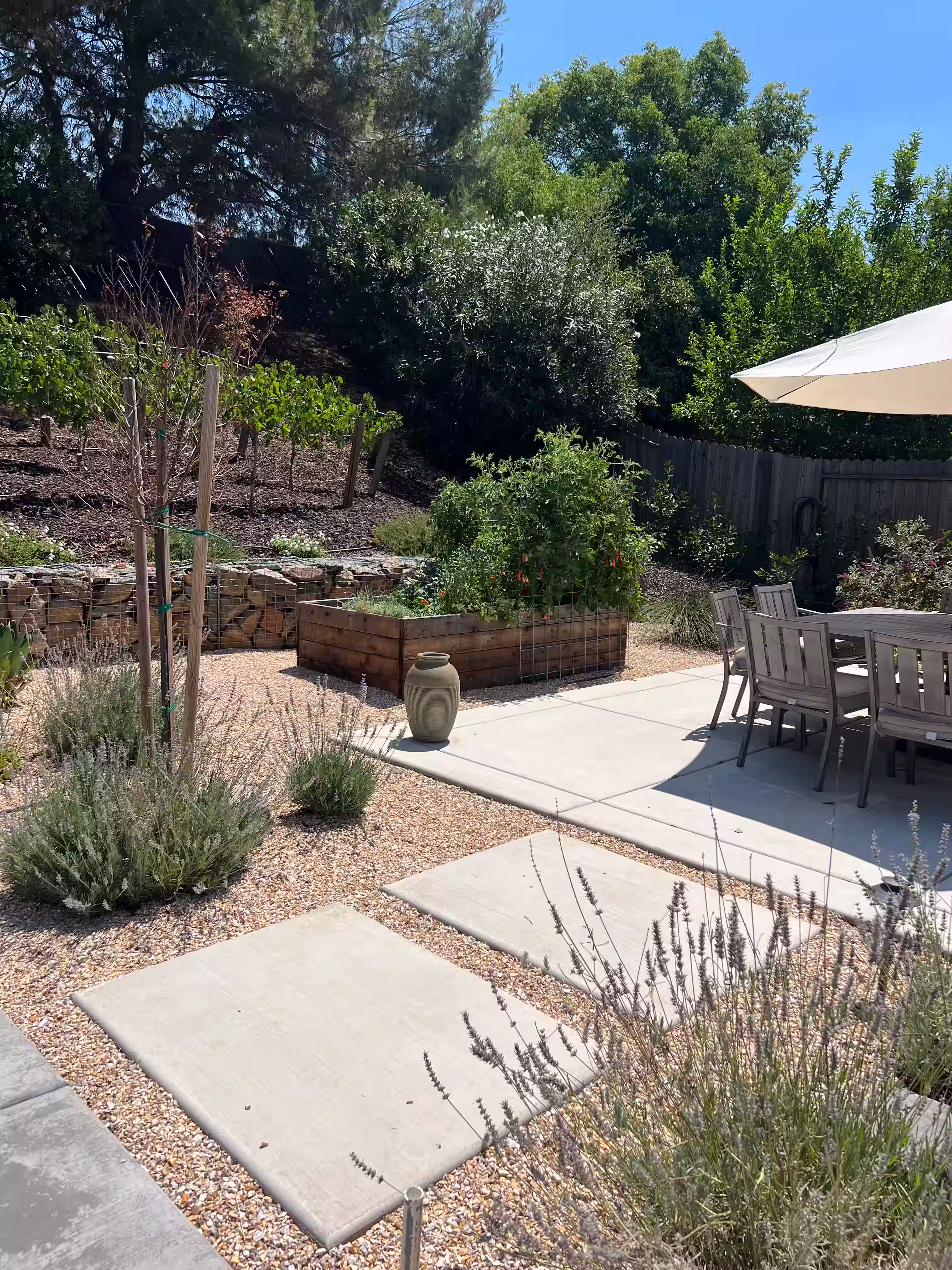 Mediterranean retreat with concrete pathways and a large outdoor seating area