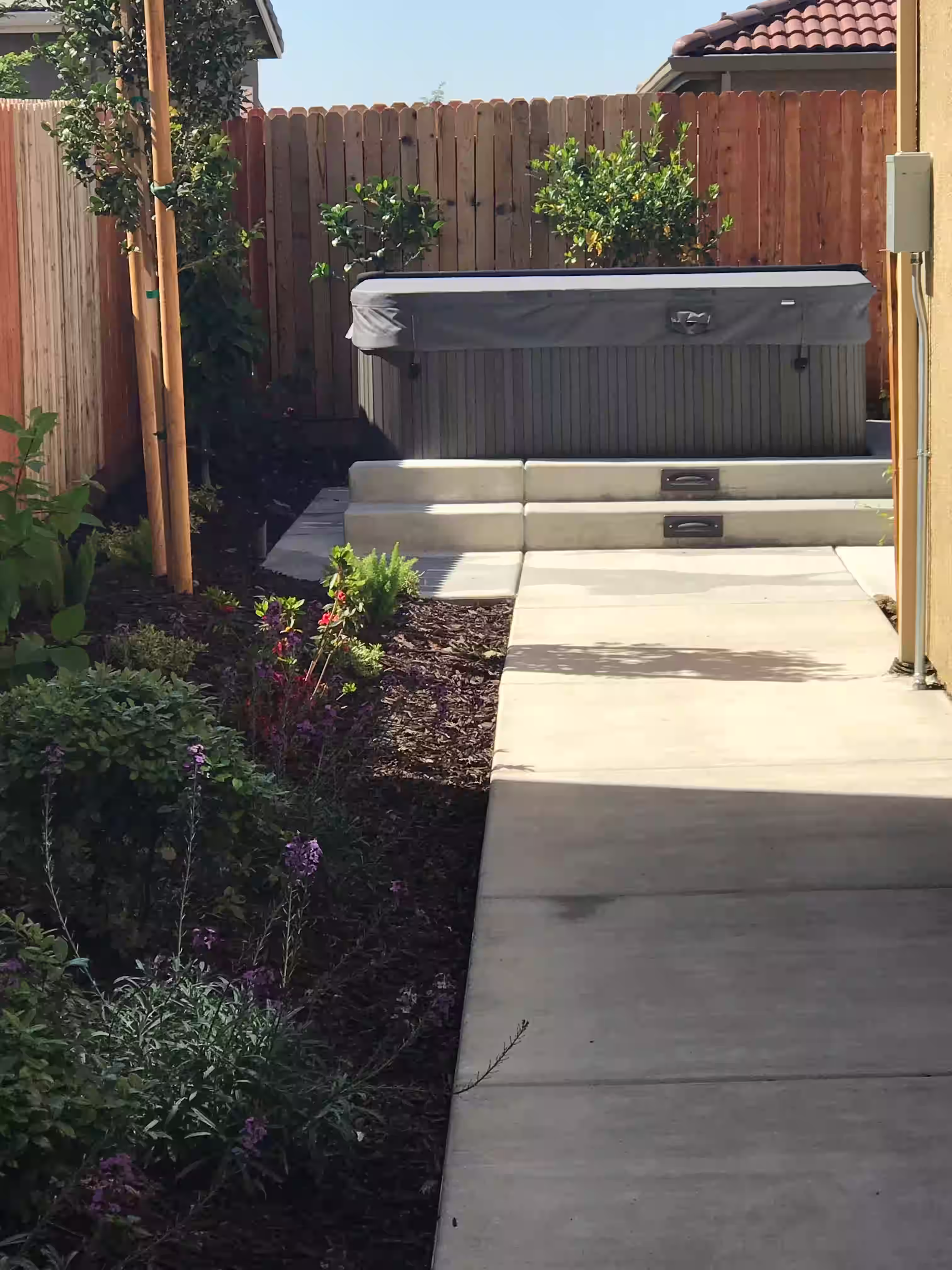 Concrete walkways leading to outdoor spa