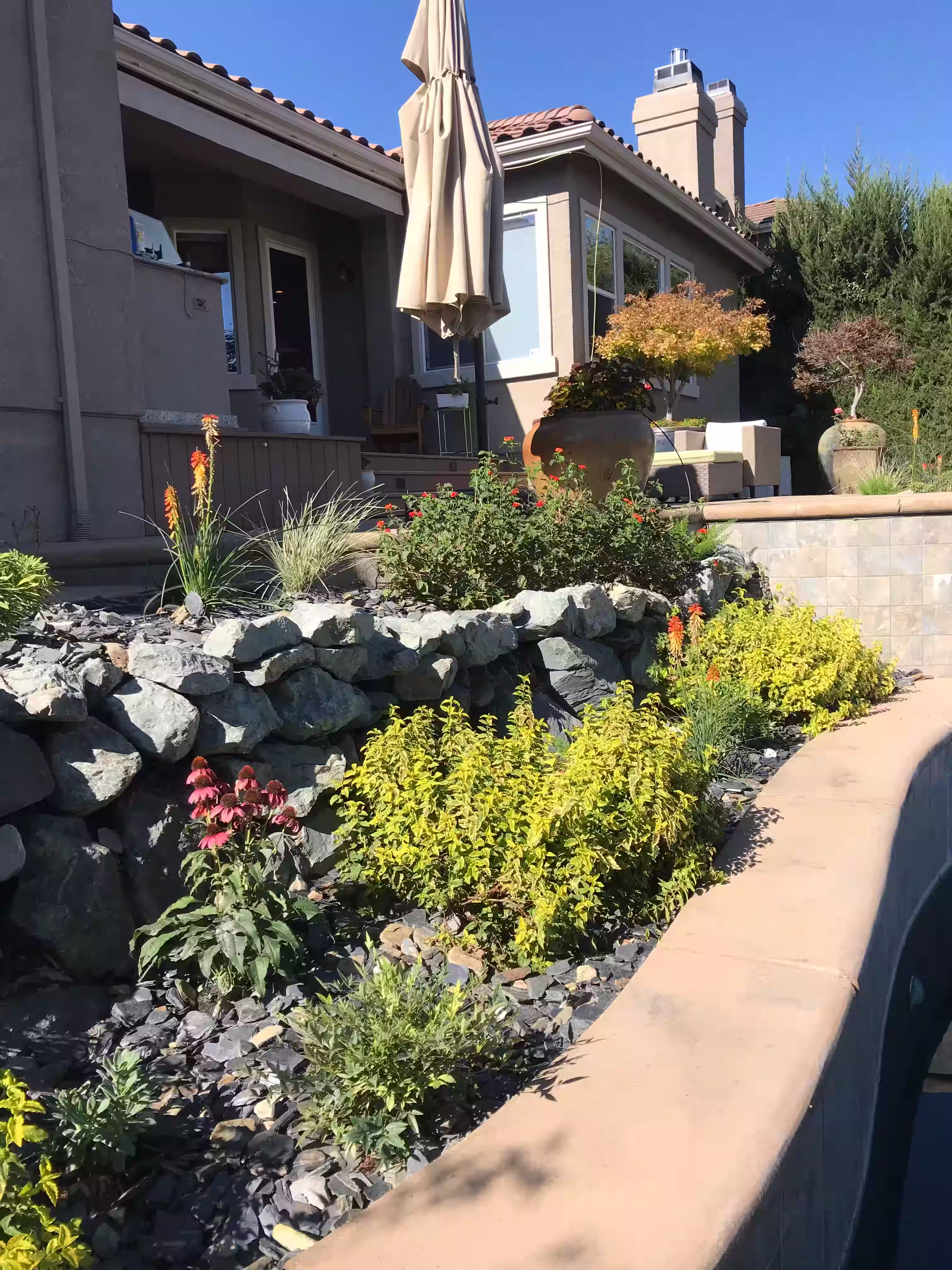 Retaining walls with large stones and layered landscaping