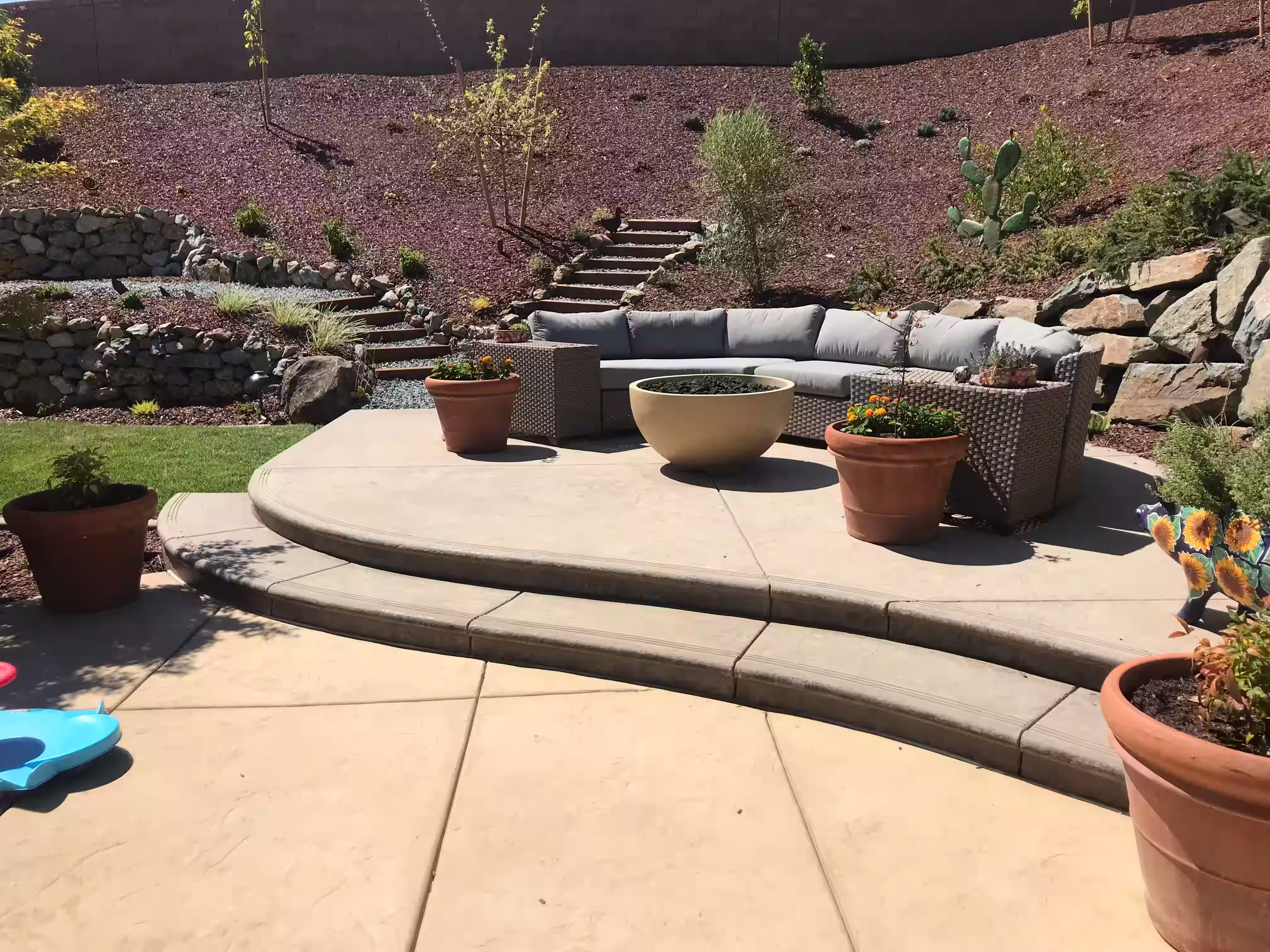 Thoughtful, integrated sitting areas layered with pathways and hillside landscaping