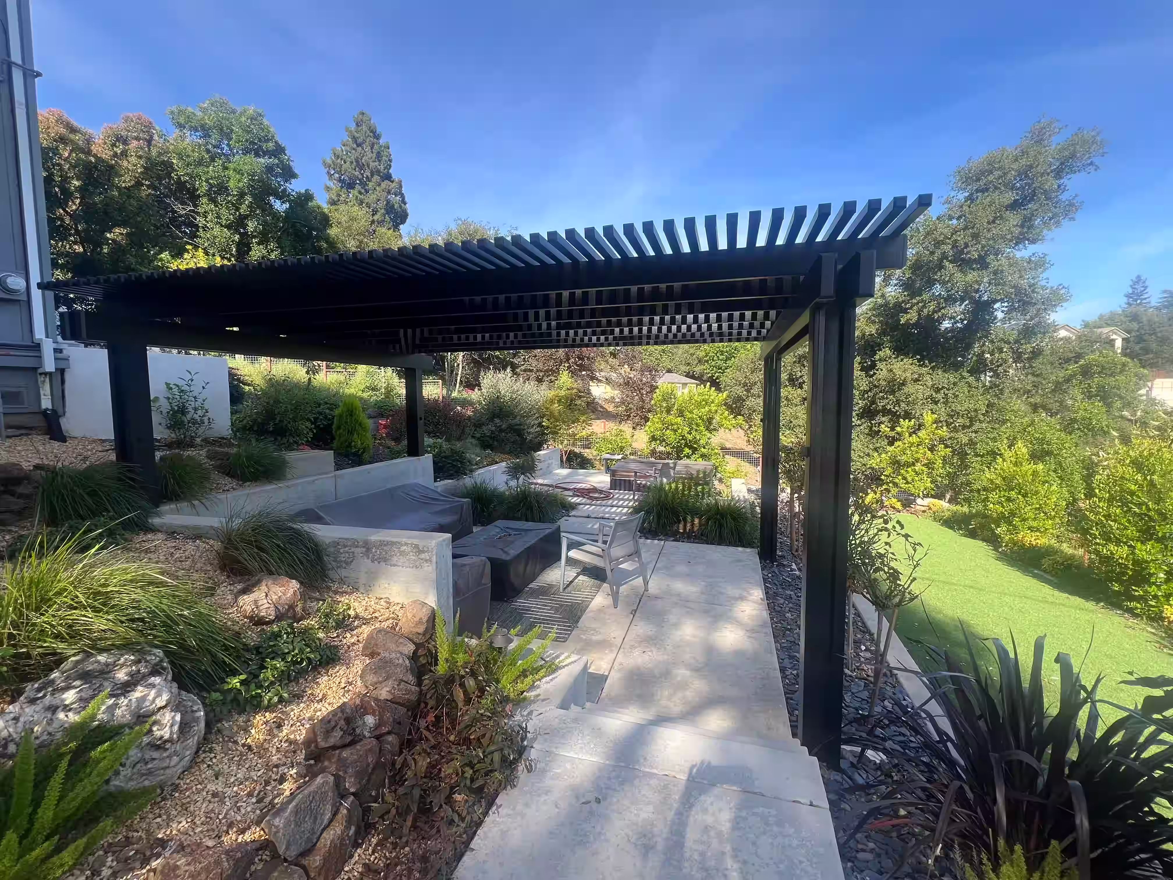 Sitting area with retaining walls, hardscape, and pergola
