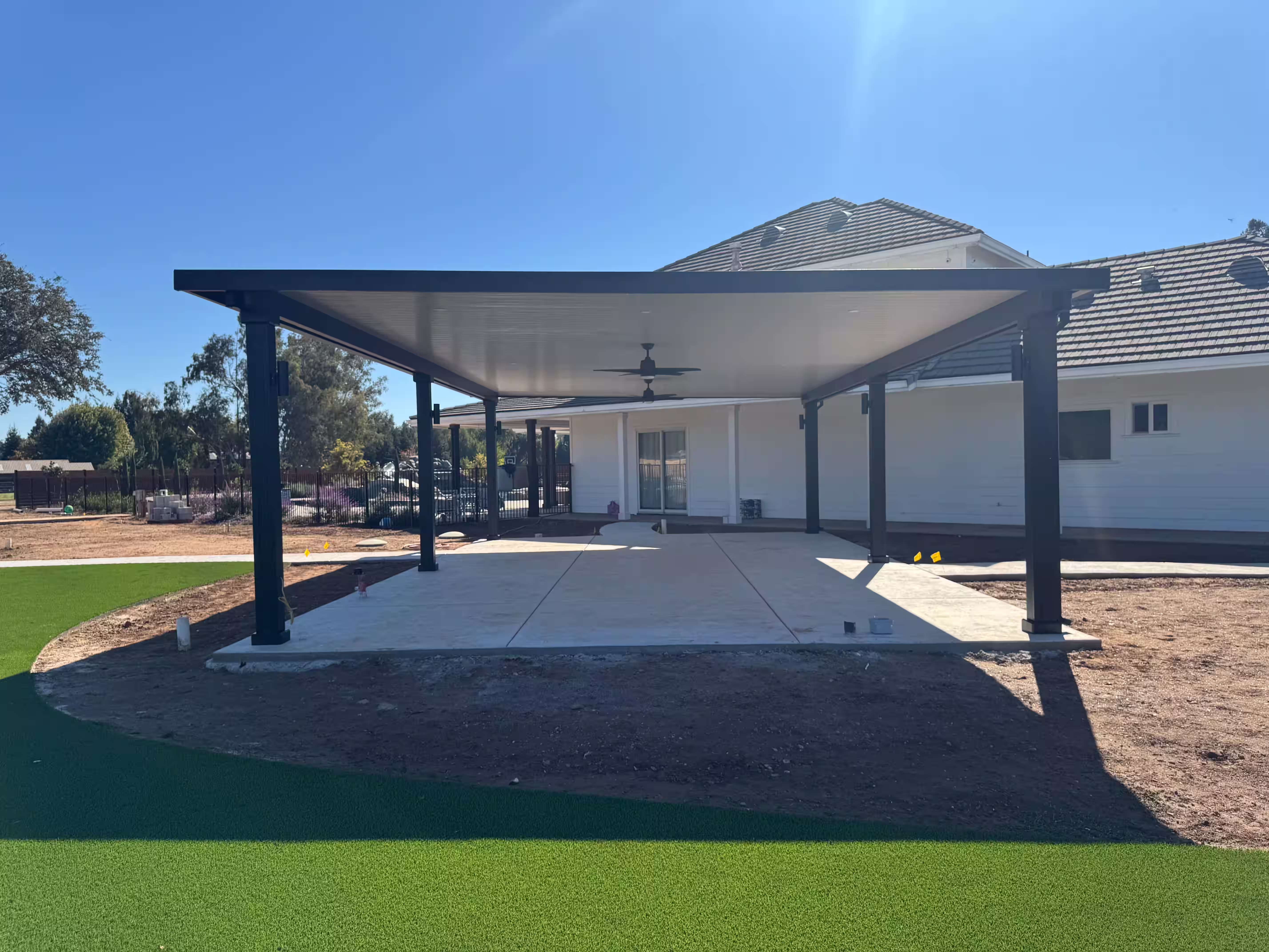 Patio with ceiling fans and a large concrete slab
